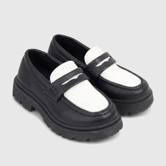 Klevas Boys black and white chunky sole loafer with textured leather upper, featuring a prominent lug sole, viewed from the