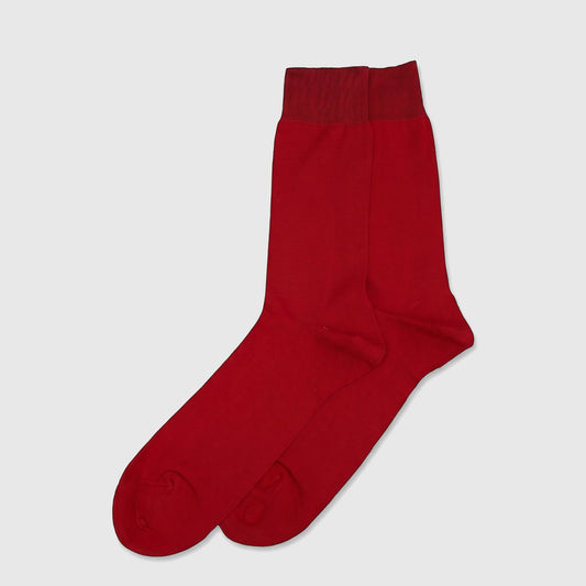 A pair of vibrant red men's mercerised cotton socks, folded neatly and displayed in a flat-lay studio shot.