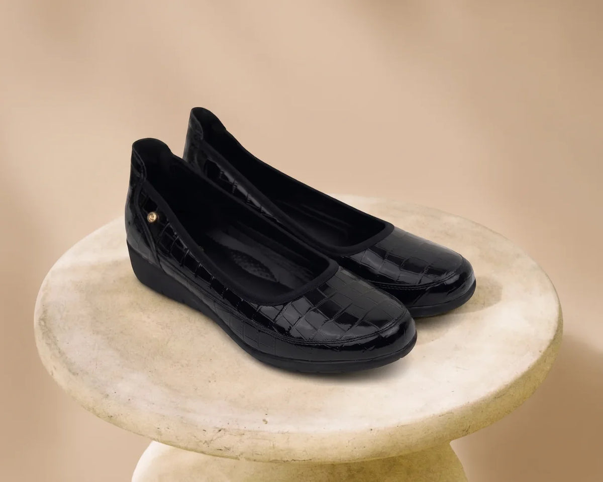 Black PC Ladies Comfort Pump PCL10999 with a knitted upper and a velcro strap, viewed from the side profile.