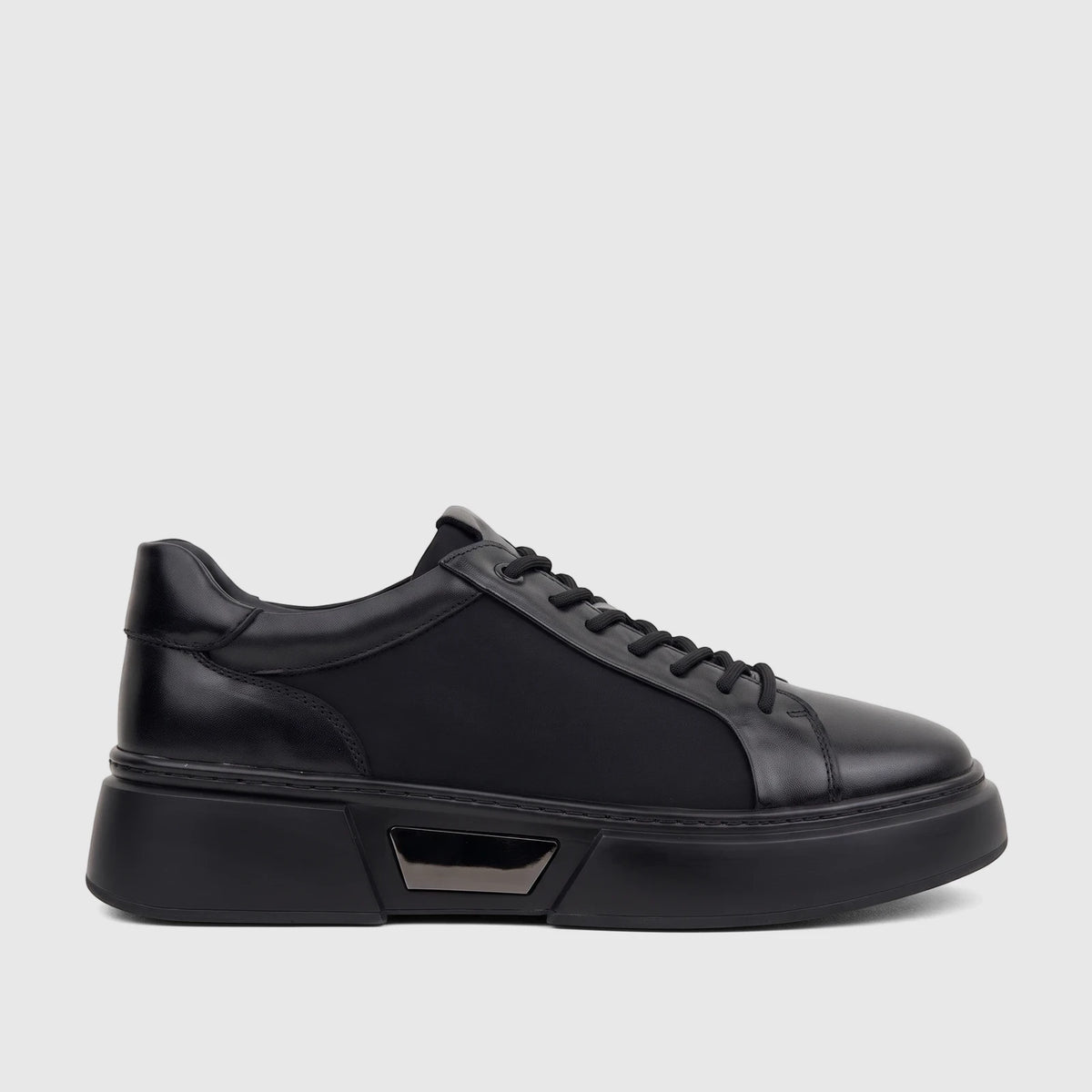 A single men's Babucci K13050401-1 black leather sneaker with a thick sole and prominent lacing, captured in a side view.