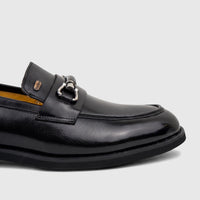 Black leather Barker men's dress slip-on loafer with a silver horse-bit detail, shown from a side view.
