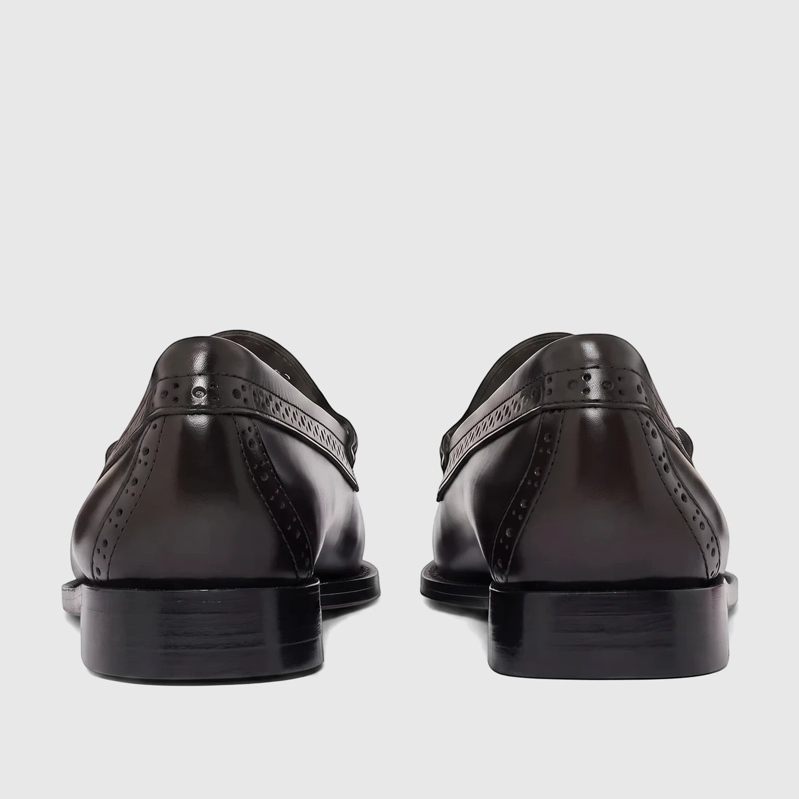 Back view of Bass Men's Loafer Weejun Venetian Brogue in black leather, showcasing the detailed perforations and glossy