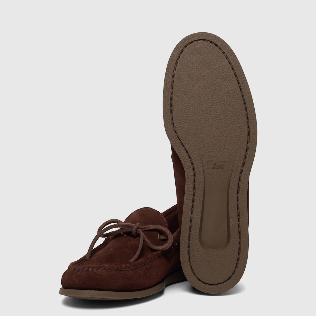 Men's chocolate suede Bass Camp Moc Decker loafers, shown from a raised sole perspective with another loafer beside it.