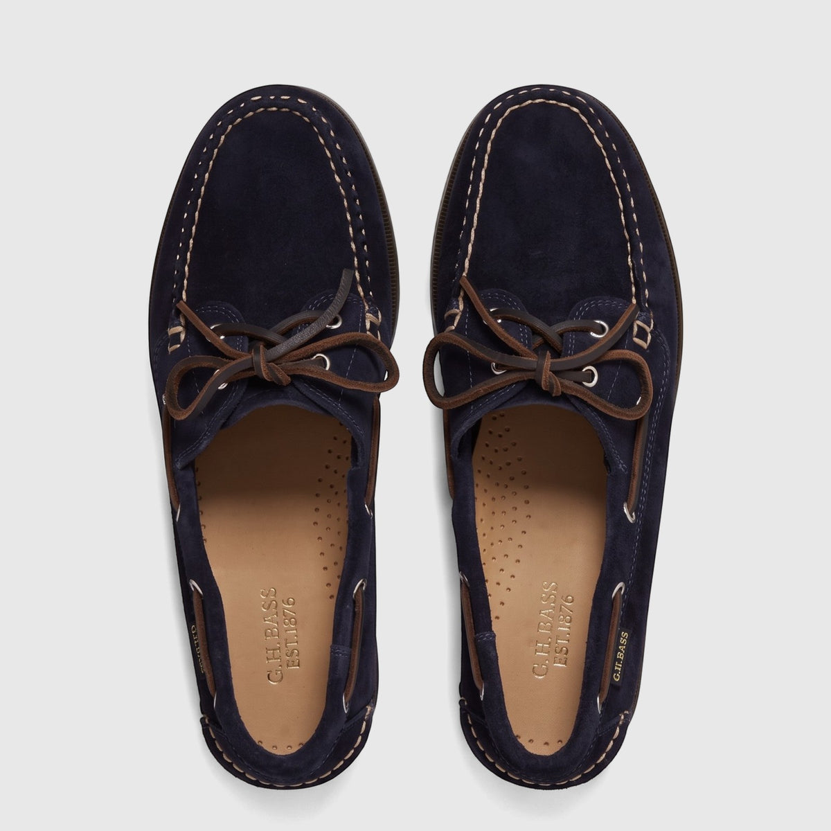 Overhead view of a pair of navy suede Bass Men's Jetty II Boater boat shoes with brown leather laces.