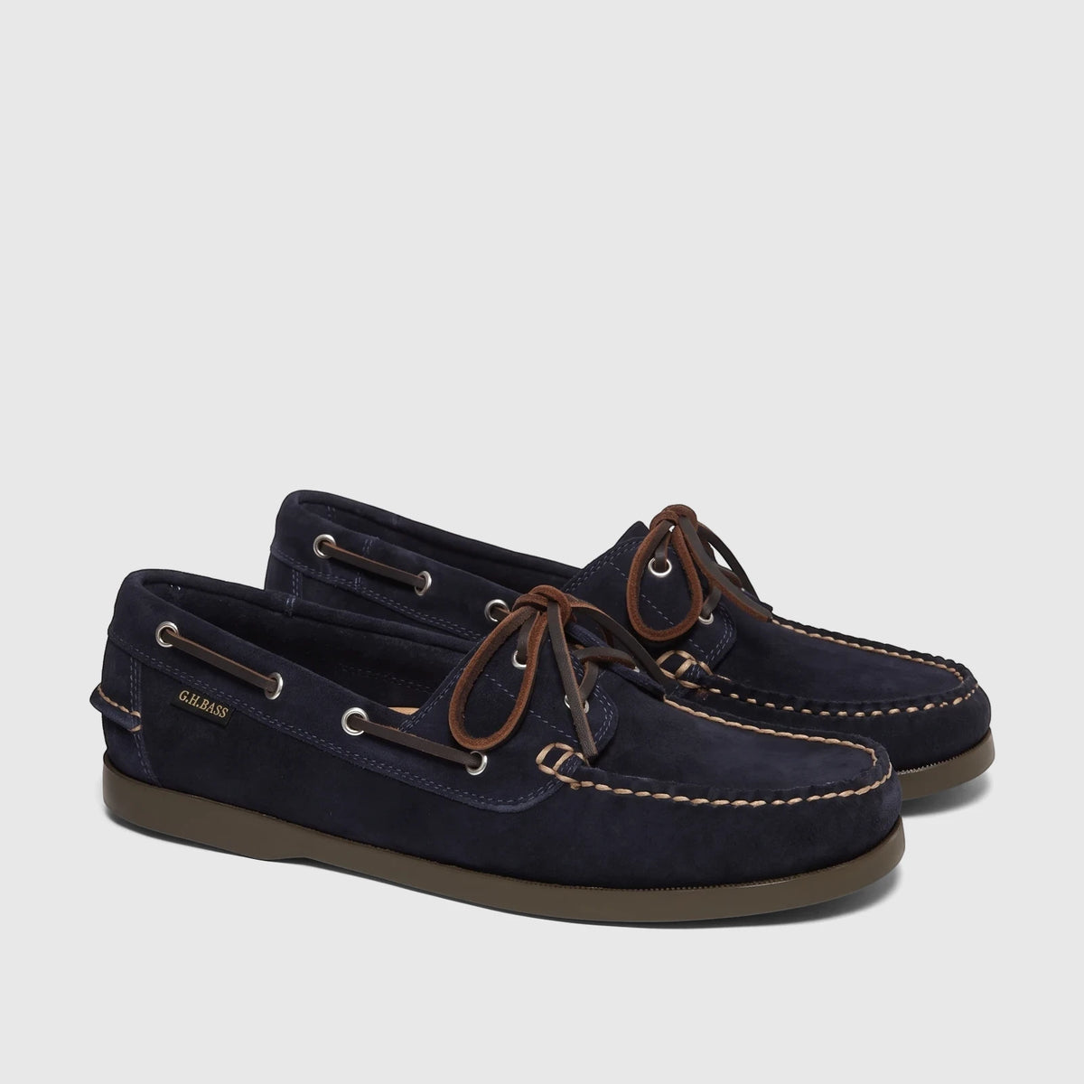 Pair of Bass Men's Jetty II Boater shoes in navy suede with brown leather laces and visible stitching, displayed.