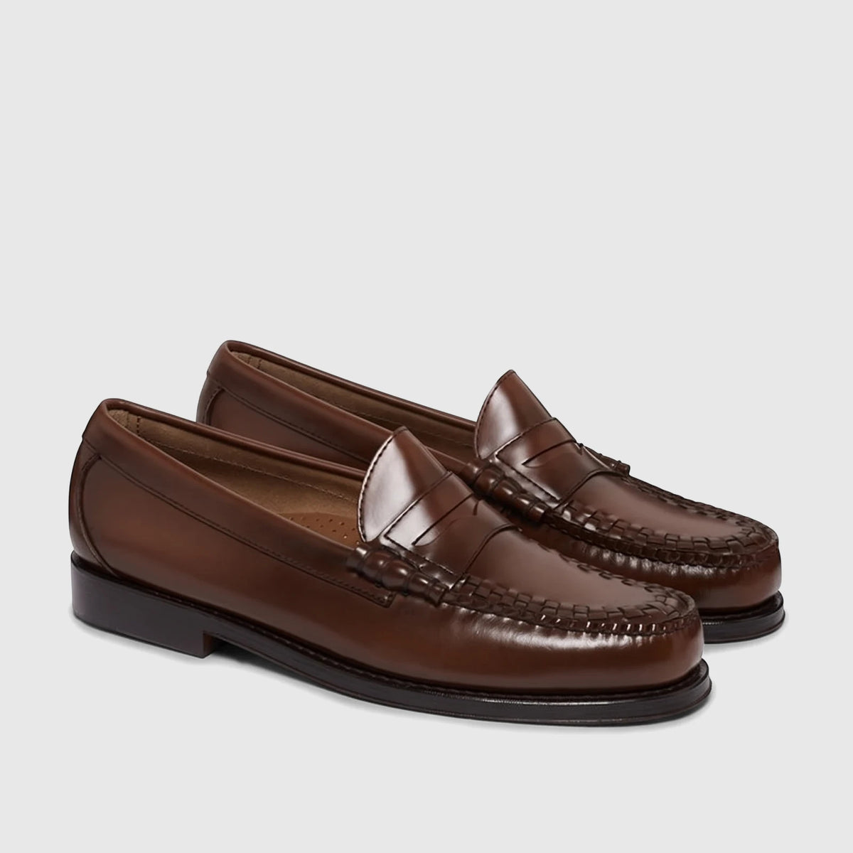 A pair of Bass Men's Loafer Larson Weave mid brown leather penny loafers, featuring intricate woven detailing on the vamp,