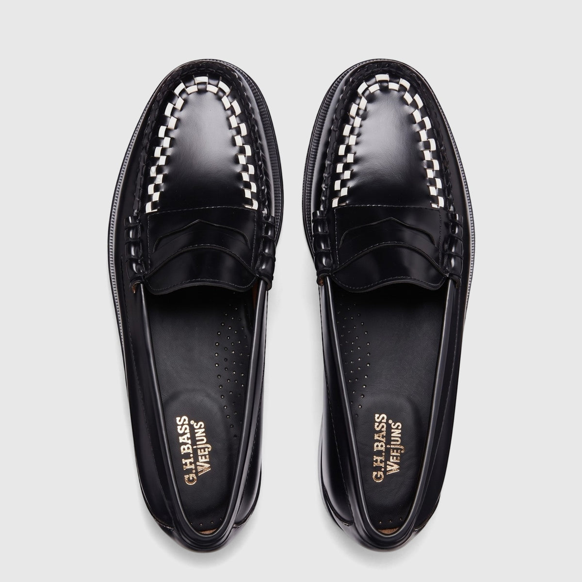 Top-down view of Bass Men's Larson Weave Penny Loafers in black and white leather with a distinctive checkerboard detail.