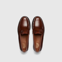 Pair of Bass Men's Weejun Logan penny loafers in brown leather, presented in an overhead studio shot.