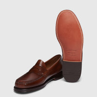 Bass Men's Weejun Logan penny loafers in brown leather, showcasing the top and sole of the shoe.