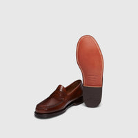 Bass Men's Weejun Logan Penny Loafer in brown leather, showing the top and sole of the classic shoe.