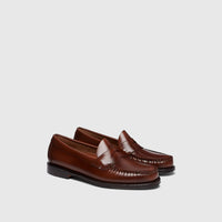 A pair of classic Bass Men's Weejun Logan Penny Loafers in rich brown leather, showcasing the side and top profiles on a