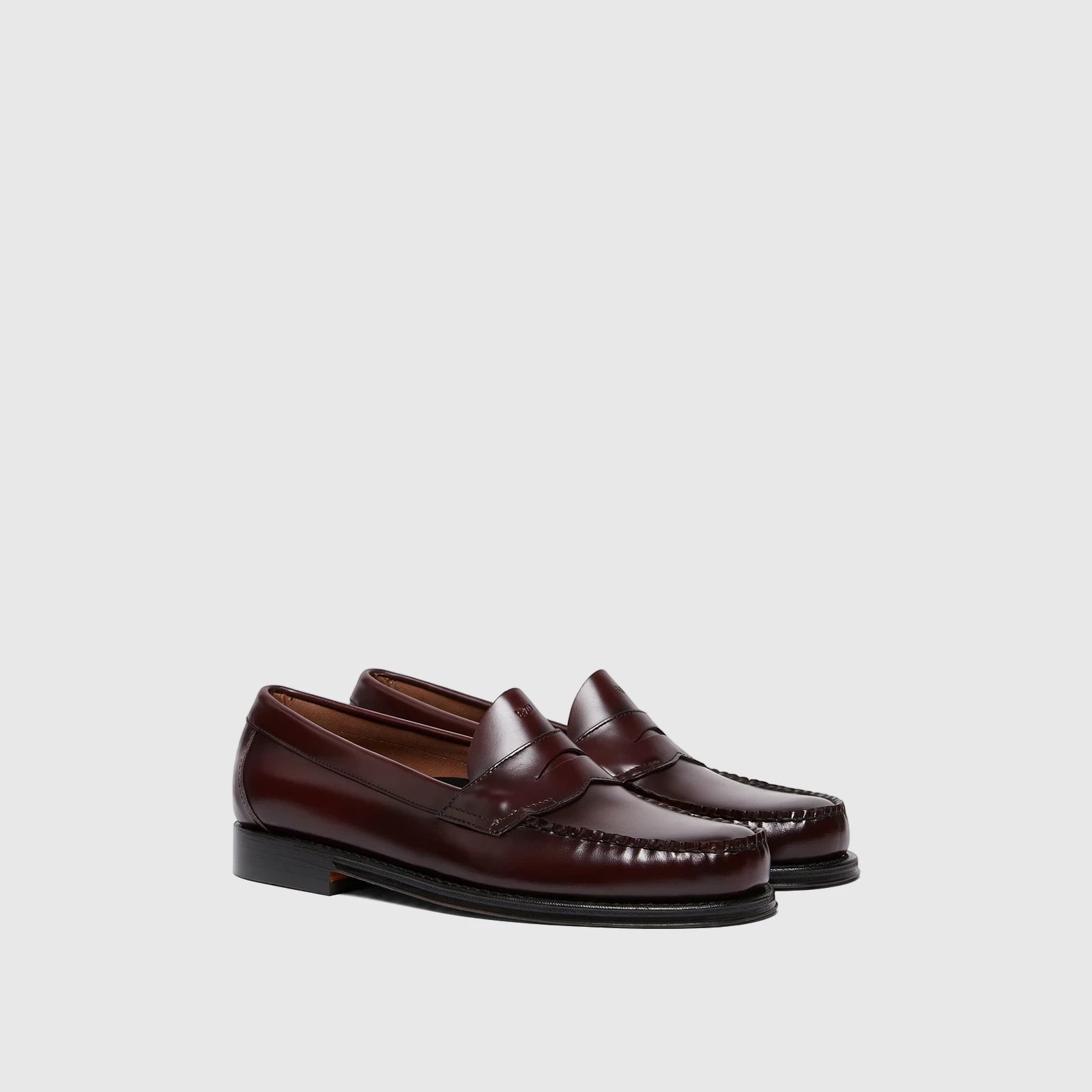 Pair of Bass Men's Weejun Logan Penny Loafers in rich wine leather, showcasing the classic penny strap and stitch detailing.