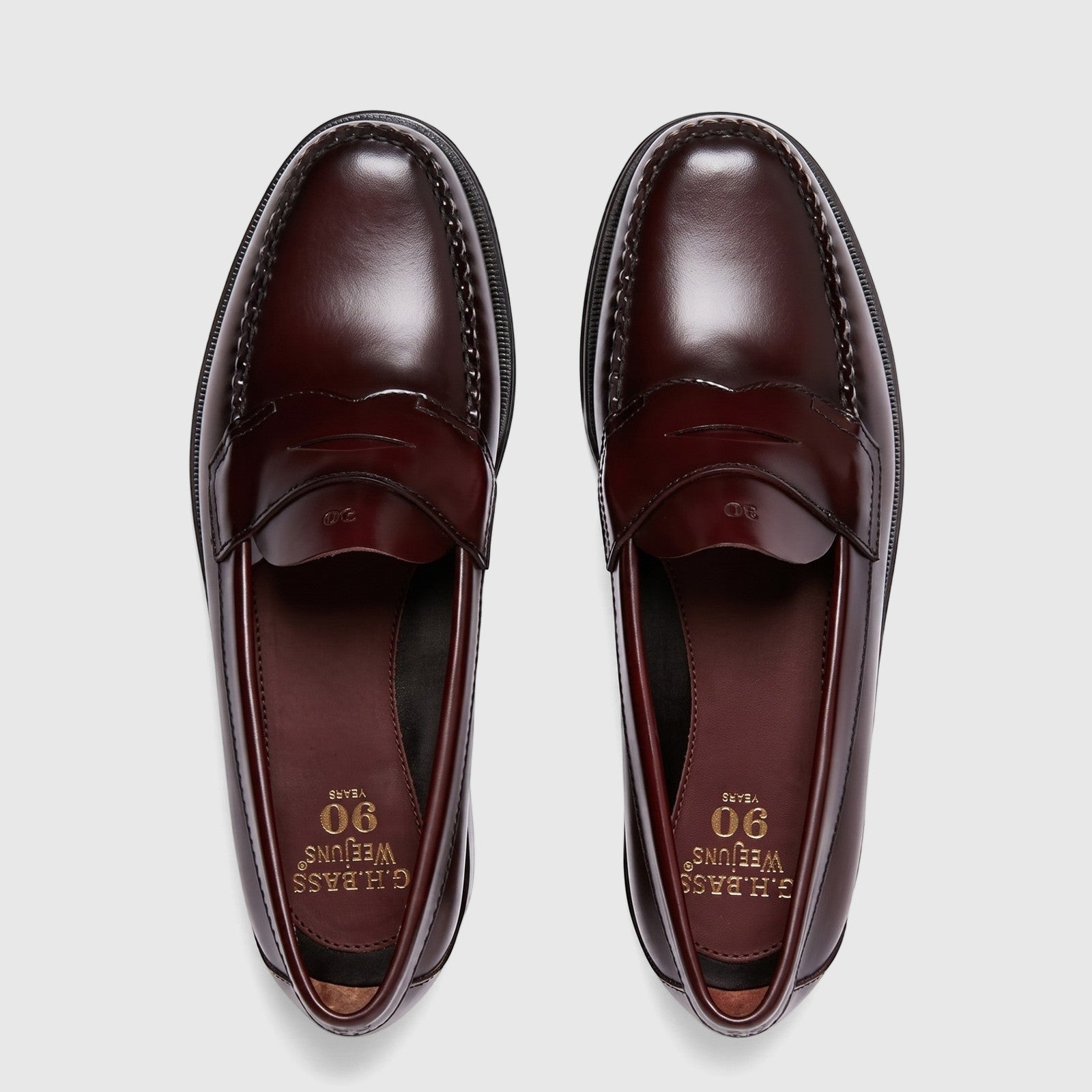 Pair of Bass Men's Weejun Logan Penny Loafers in rich wine leather, viewed from above, showcasing classic design.