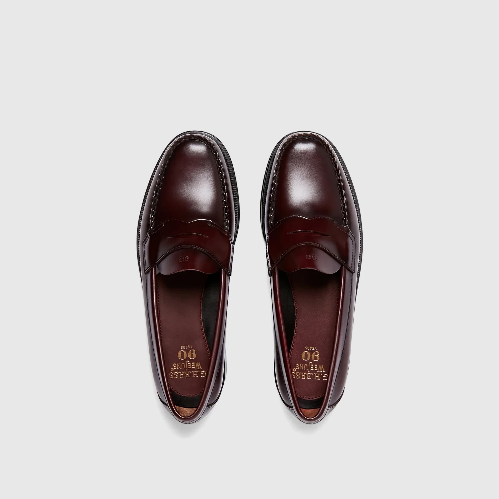 Pair of Bass Men's Weejun Logan Penny Loafers in wine-colored polished leather, shown from a top-down perspective.