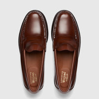 Top-down view of a pair of classic Bass Men's Weejun Logan penny loafers in rich brown leather, showcasing moc-toe stitching