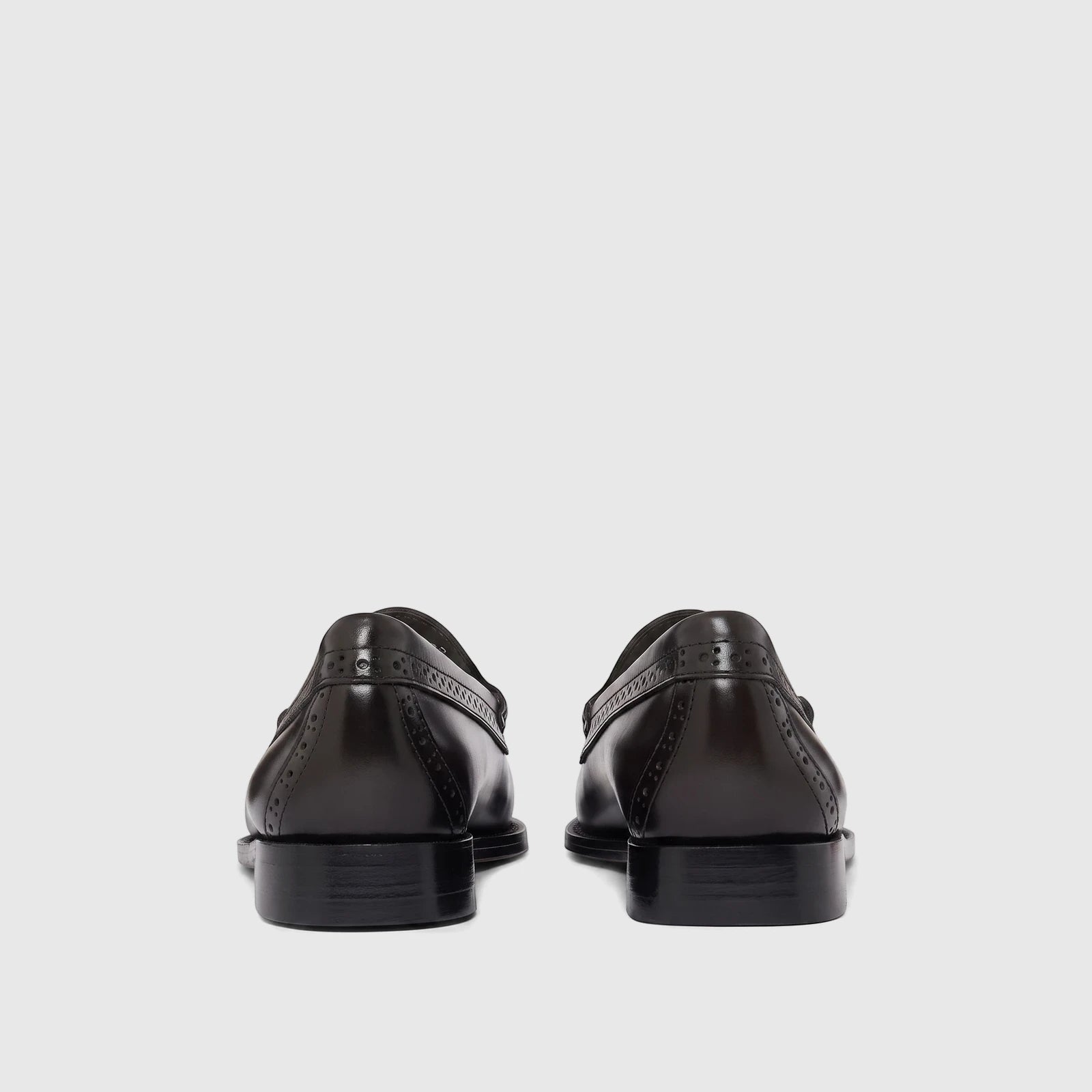 Rear view of Bass Men's Weejun Venetian brogue loafers in polished black leather, with intricate detailing on the heel.