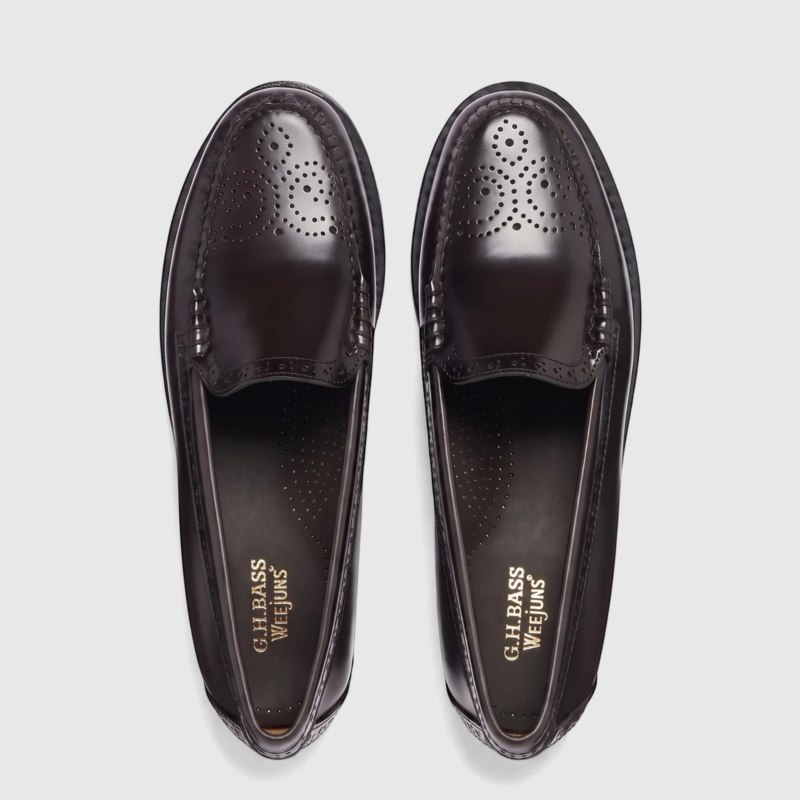 Pair of Bass Men's Weejun Venetian Brogue BA11007 black leather loafers with intricate perforated detailing, seen from a