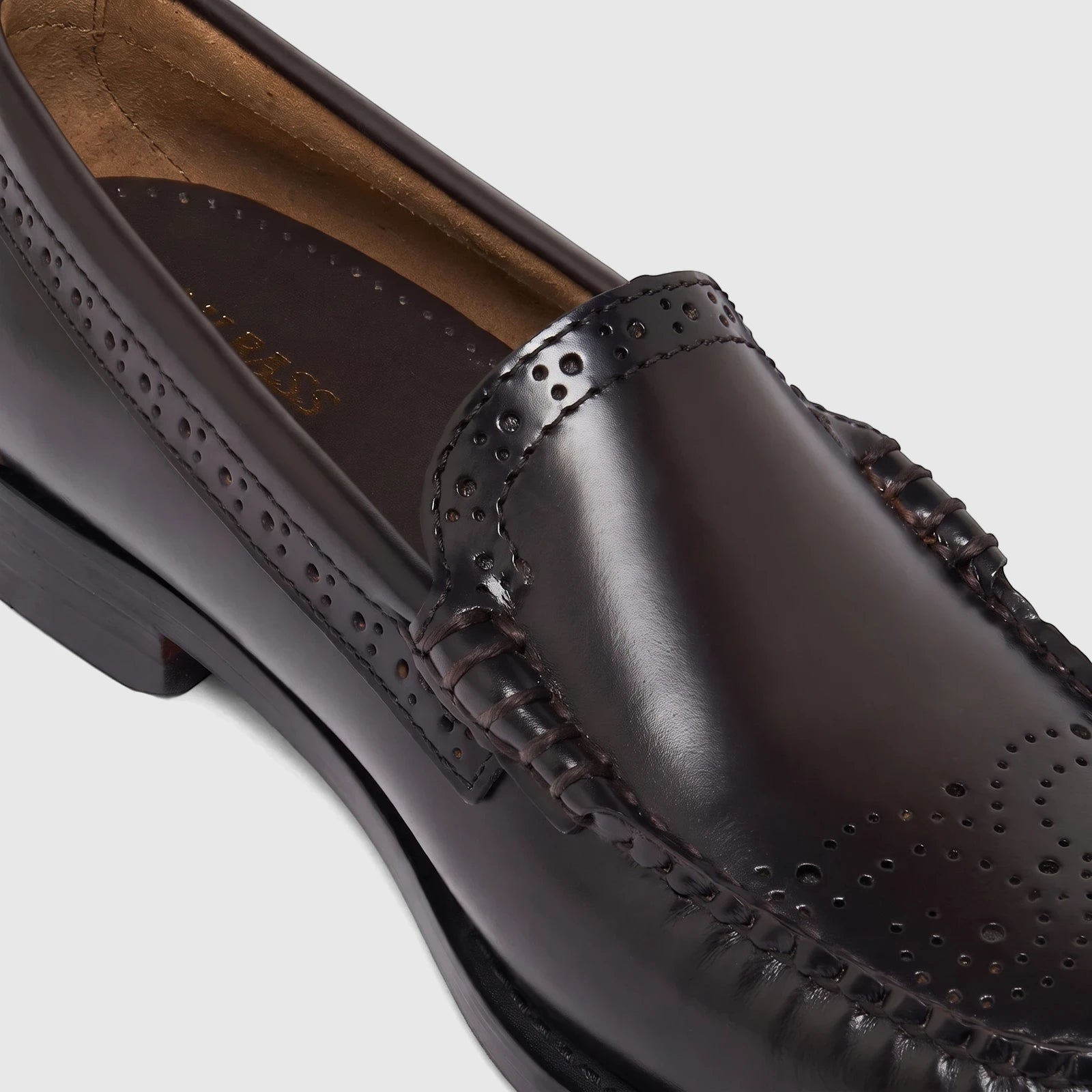 Close-up of a Bass Men's Weejun Venetian Brogue loafer in polished dark brown leather with intricate perforated detailing