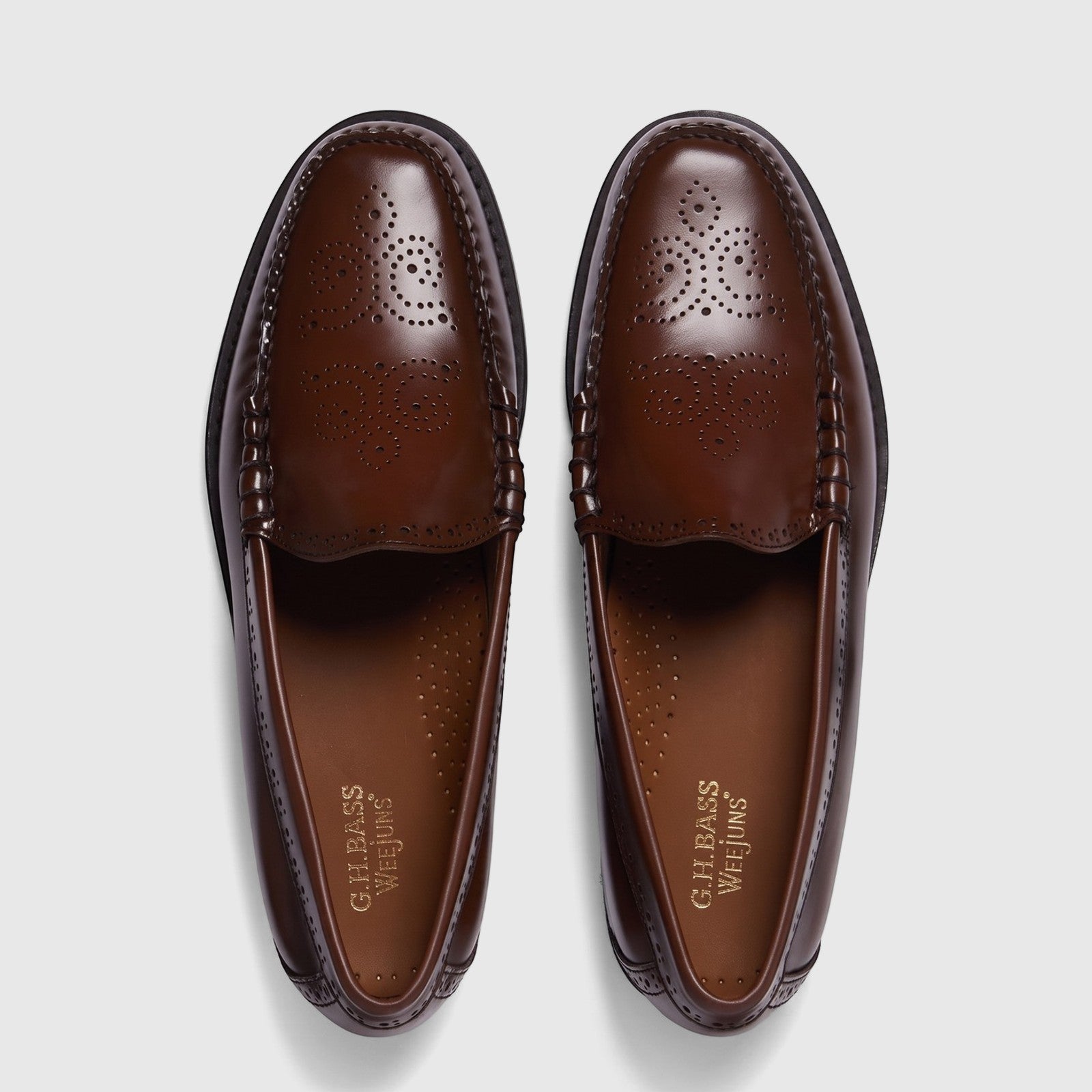 Brown leather G.H. Bass Weejun Venetian brogue loafers for men, shown from a top-down perspective on a white background.