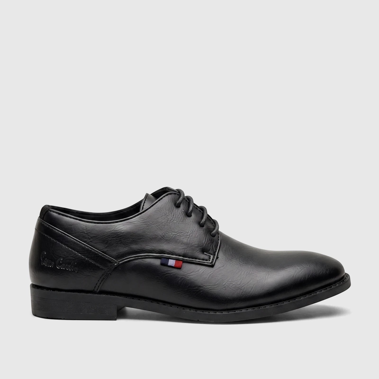 Black boys' youth dress lace-up shoe in a formal style, featuring a textured finish and a subtle colored stripe detail.
