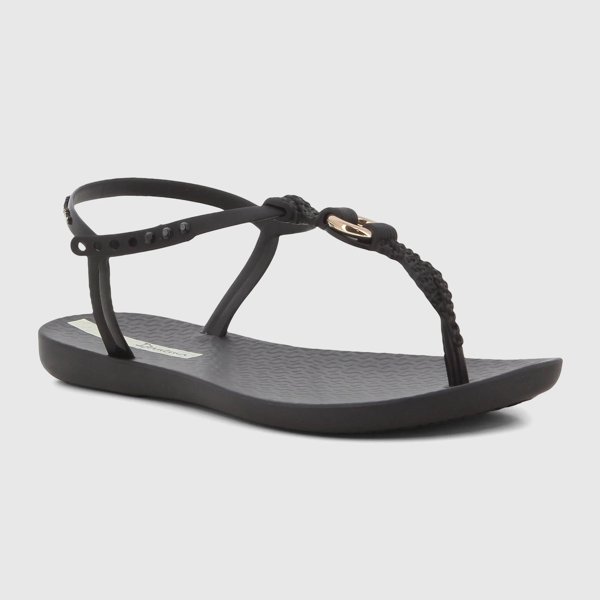 Black Ipanema Class Luma thong sandal with braided T-strap and gold accent, featuring an adjustable ankle strap.