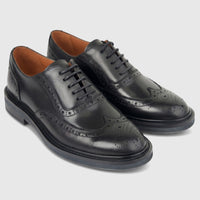 Pair of black leather ladies' formal full brogue wingtip lace-up shoes with intricate perforations and a polished finish.