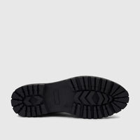Bottom view of a black lug sole boot, showcasing its robust, patterned tread. Used for the PC Ladies Casual Loafer PCL10997.