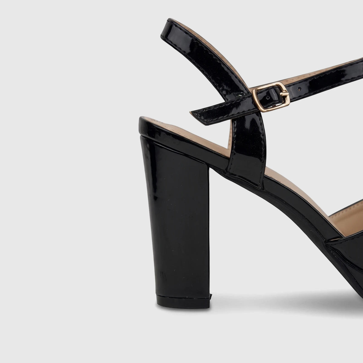 Black patent leather Bulbul Ladies Dress Block Heel Sandal with a shiny finish, adjustable ankle strap, and gold buckle.