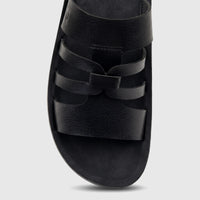 Close-up of a single black PC Ladies Casual Sandal with multiple textured leather straps and a comfortable footbed.