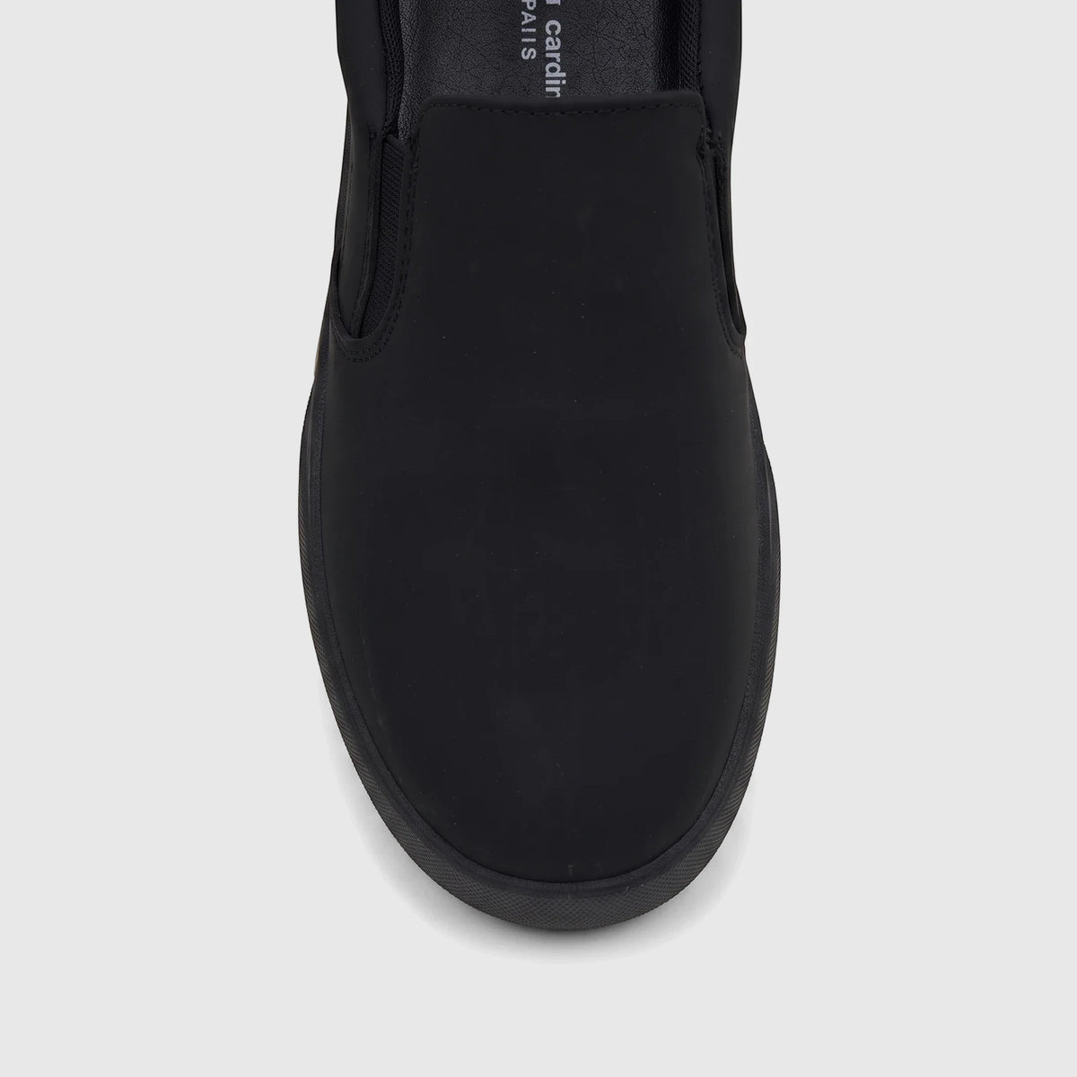 Close-up top view of a black PC Ladies Casual Slip On Sneaker with an elastic gore, on a white background.