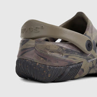 Rear view of a men's Bogs By Florsheim Comfort Clog in khaki camo, featuring a textured black sole and heel strap.