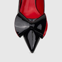Bulbul black patent dress court shoe, front view, with a pointed toe, large black bow, and contrasting red interior.