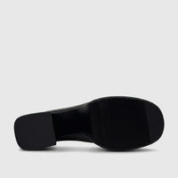 Bulbul Ladies black block heel Mary Jane shoe, viewed from below showing the patterned sole and block heel, with green