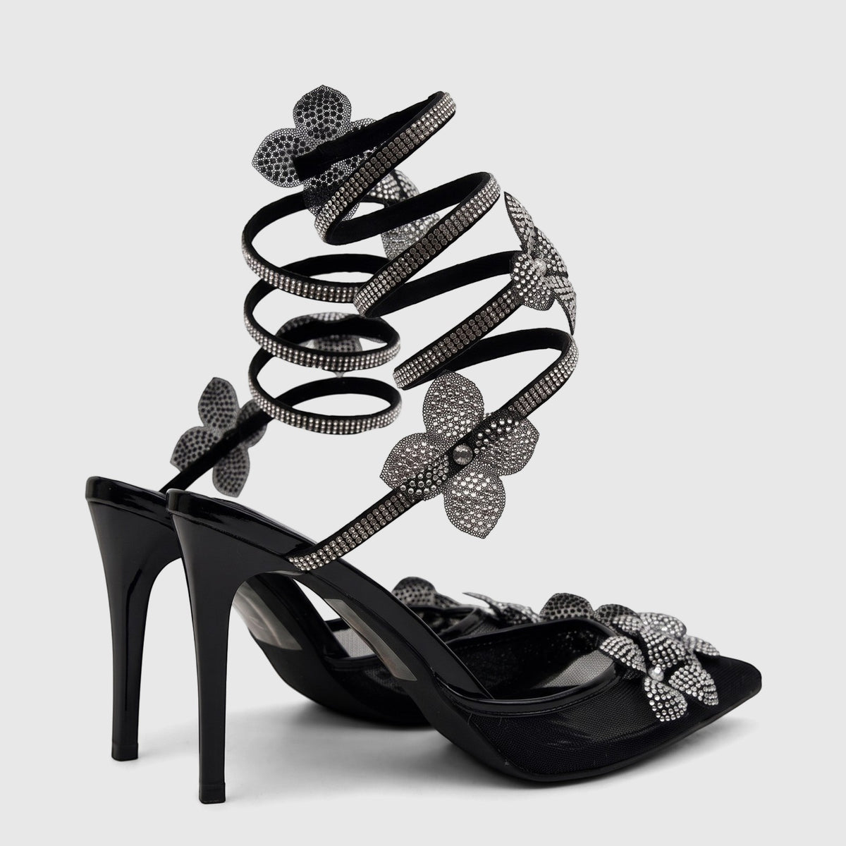 Bulbul Ladies' black high-heel evening sandals with rhinestone spiral ankle straps and flower embellishments, front view.