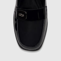 Close-up front view of a Bulbul ladies black patent loafer-style dress shoe with a decorative buckle detail.