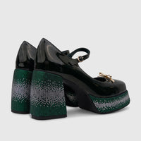 A pair of dark green patent leather Bulbul Ladies Block Heel Mary Jane shoes with sparkling rhinestone bling on the platform