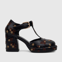Black ladies' Bulbul block heel shoe with a T-bar strap, gold buckle, and intricate floral embroidery.