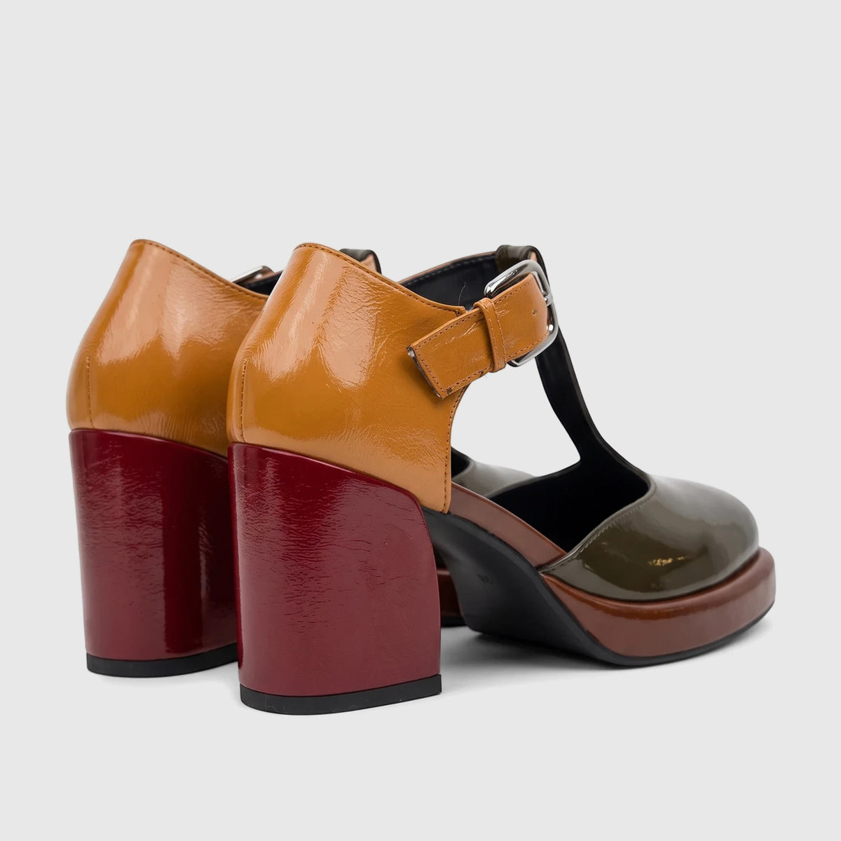 Pair of Bulbul Ladies Block Heel shoes with T-bar strap. Multi-colored patent leather-like uppers in khaki, brown,