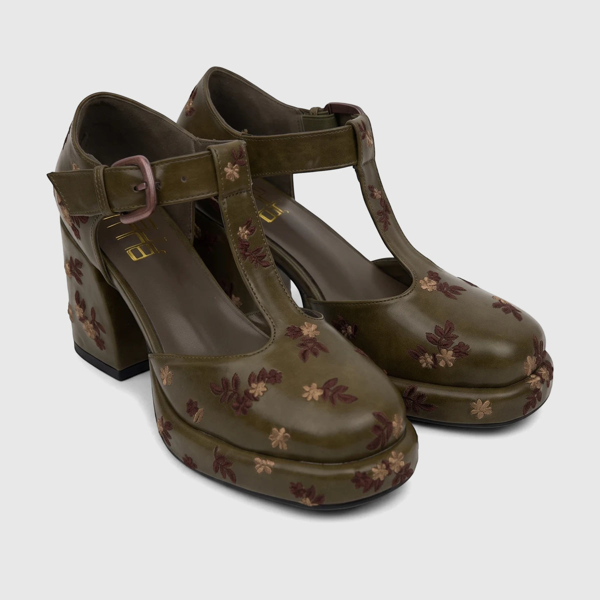 A pair of olive green Bulbul Ladies Block Heel T-bar shoes with intricate floral embroidery and platform soles on a white