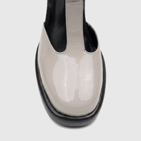 Bulbul Ladies Block Heel T-Bar shoe in off-white patent leather with a black sole, shown from a front close-up view.