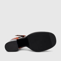 Bulbul Ladies Block Heel T-Bar shoe in orange and black, showcasing the textured sole and block heel from a bottom-side view.