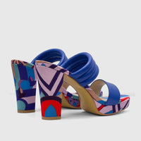 Pair of Bulbul Ladies Casual Block Heel Mule sandals in blue with a vibrant multi-colored geometric pattern, side view.