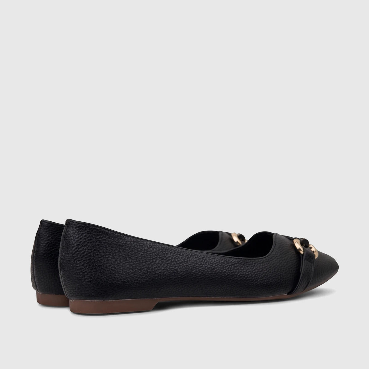 A pair of black Bulbul Ladies Casual Pumps with textured material and a gold chain-link accent, viewed from the side.