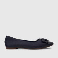 Side profile of a Bulbul Ladies Casual Pump in navy, featuring a textured upper, decorative buckle, and brown sole.