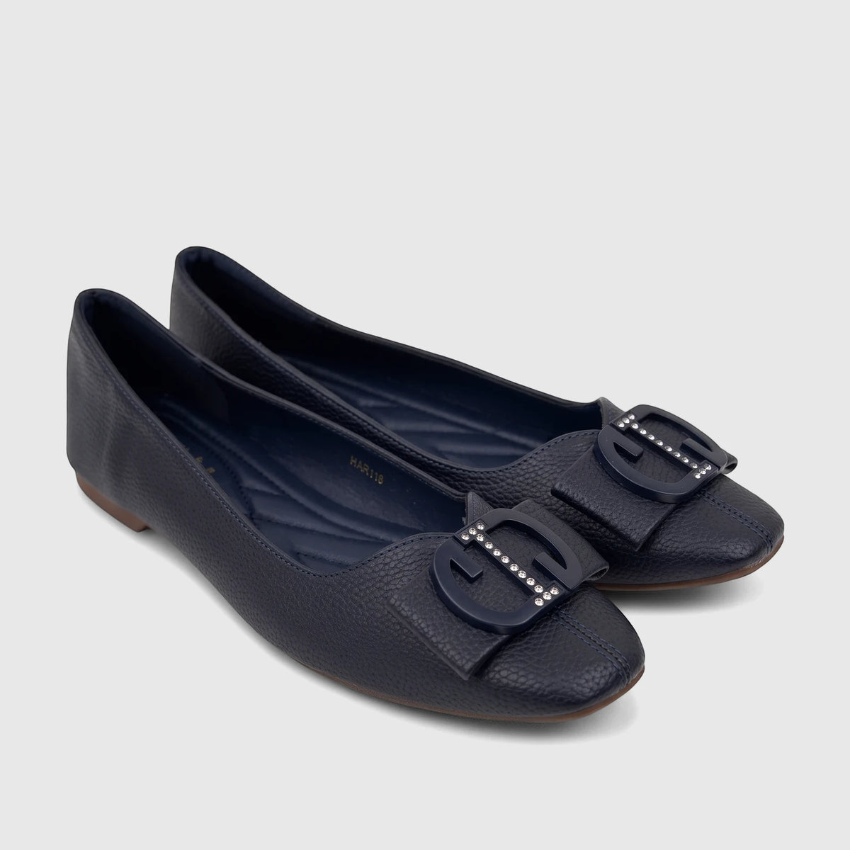 Pair of navy blue textured casual pumps with embellished buckles, offering comfort and style for women.
