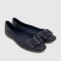 Pair of navy blue textured casual pumps with embellished buckles, offering comfort and style for women.