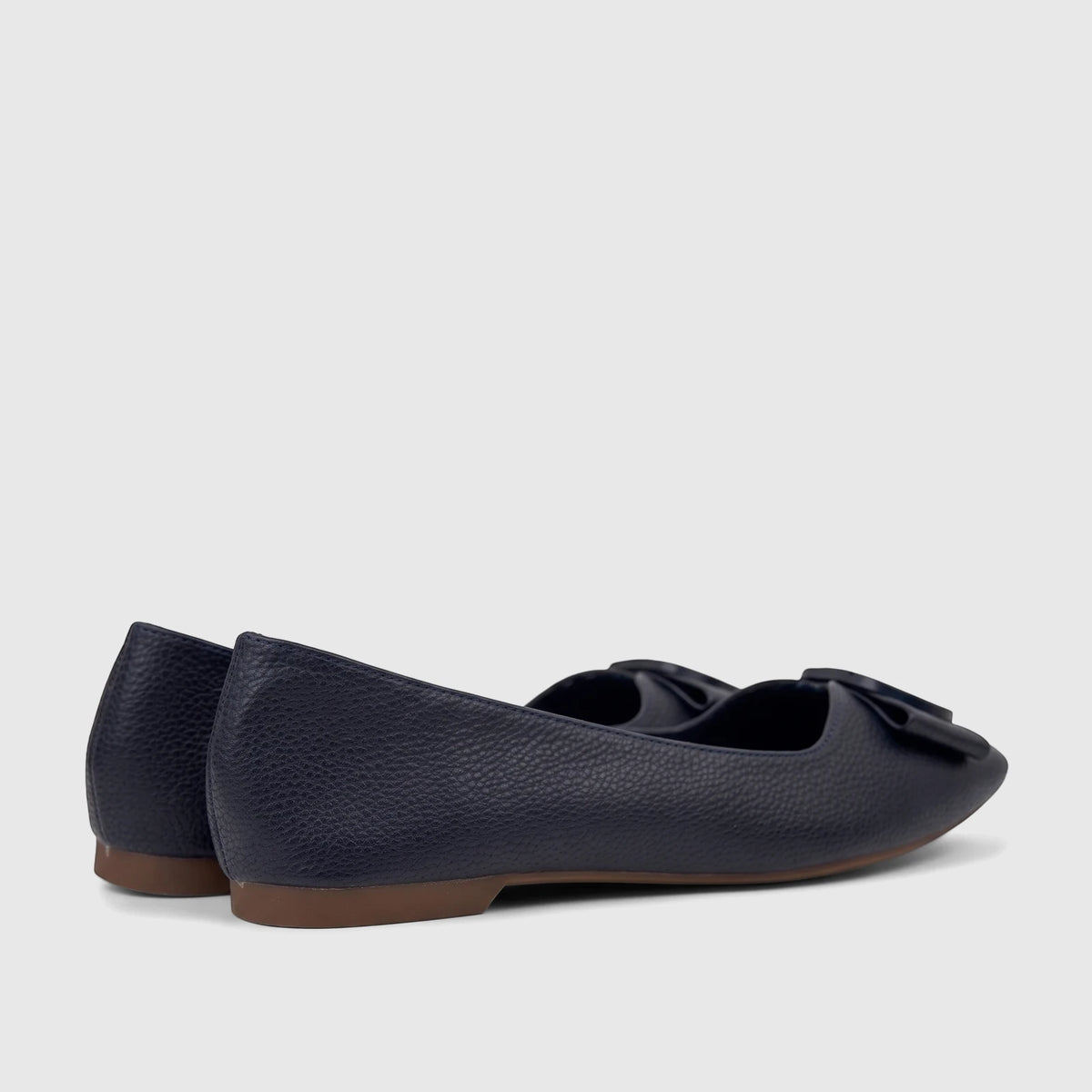Bulbul Ladies Casual Pump Navy HAR118, featuring a pebbled navy texture, decorative bow, and brown sole, viewed from the