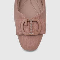 Close-up of a pink textured faux leather ladies' casual pump shoe with a rhinestone-embellished CD buckle.