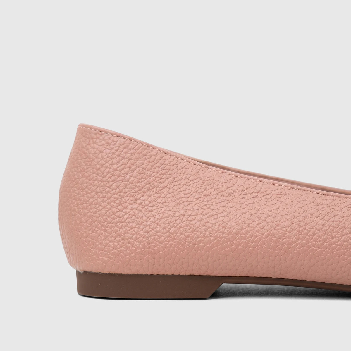 Side view of a Bulbul Ladies Casual Pump in pink, featuring a textured upper and a flat brown sole.