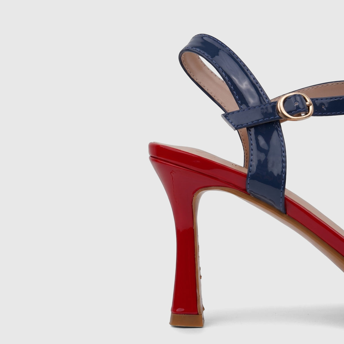 Bulbul Ladies Casual Slingback Sandal in blue and red patent leather, with a flared high heel and gold buckle.